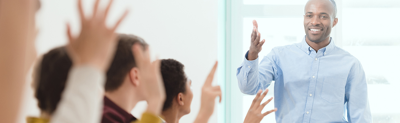 classroom-secondary-students-raising-hands-with-teacher