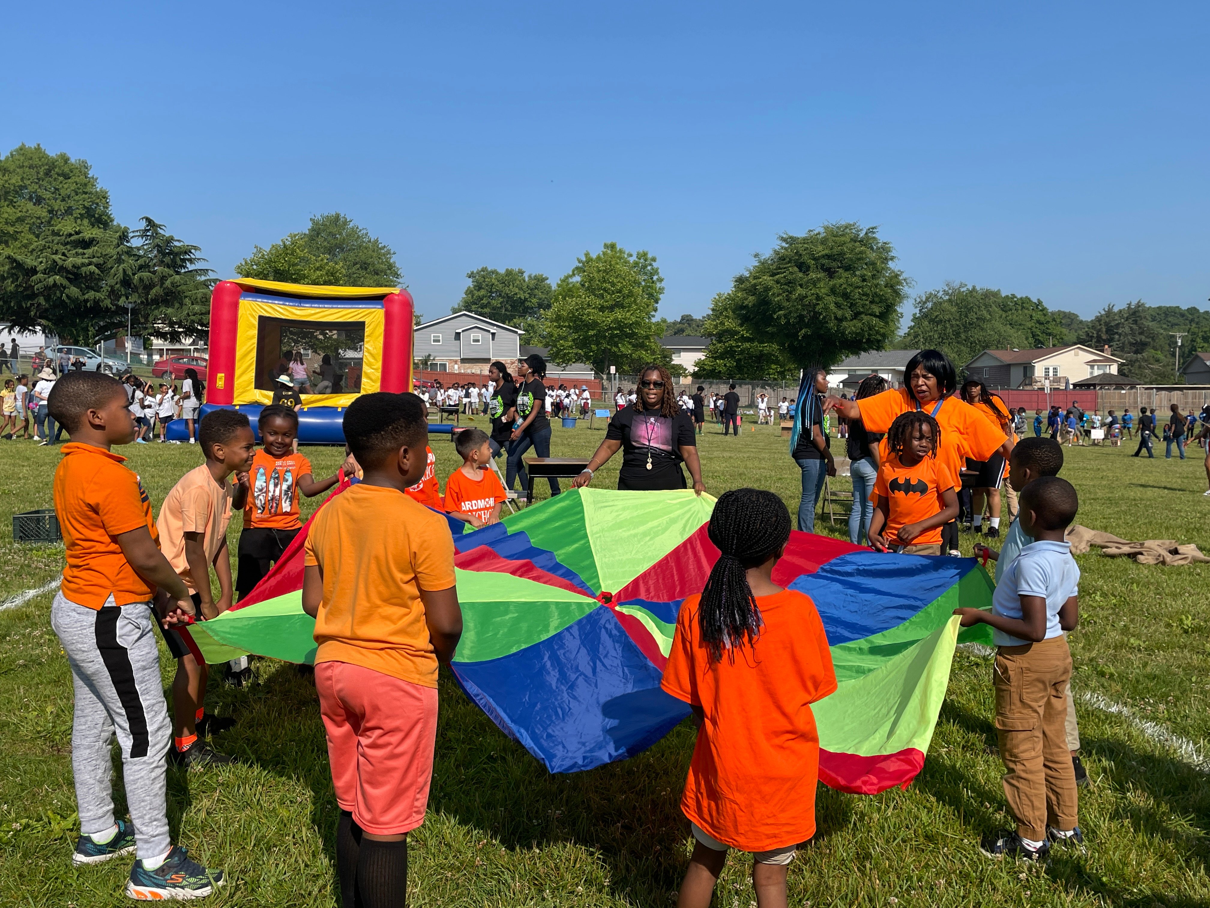 Children and teachers playing parachute game