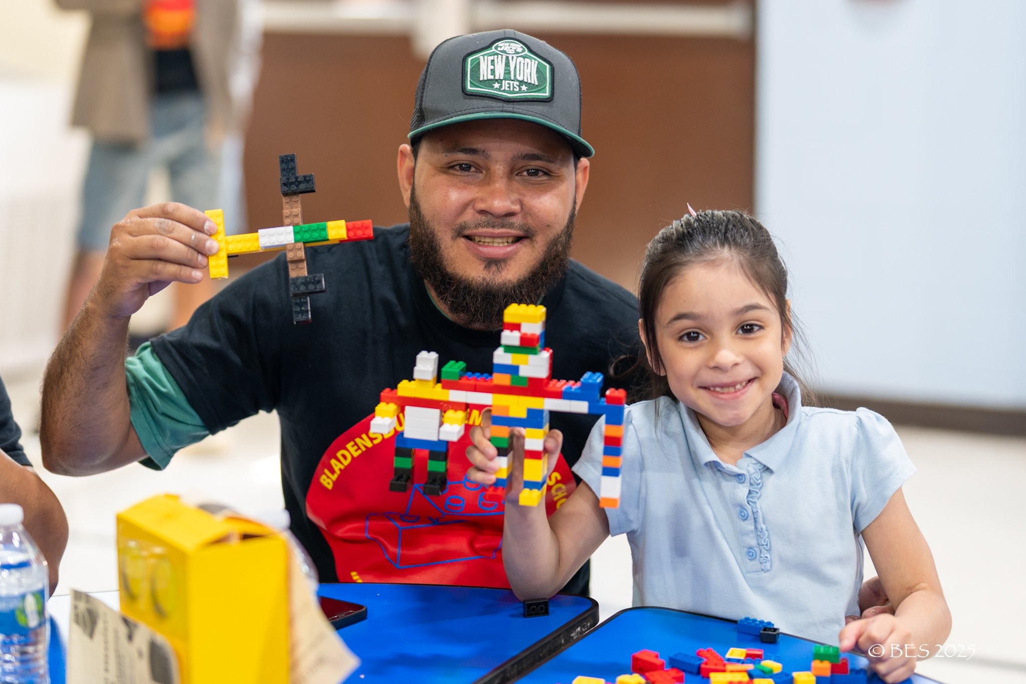 man girl showing lego blocks