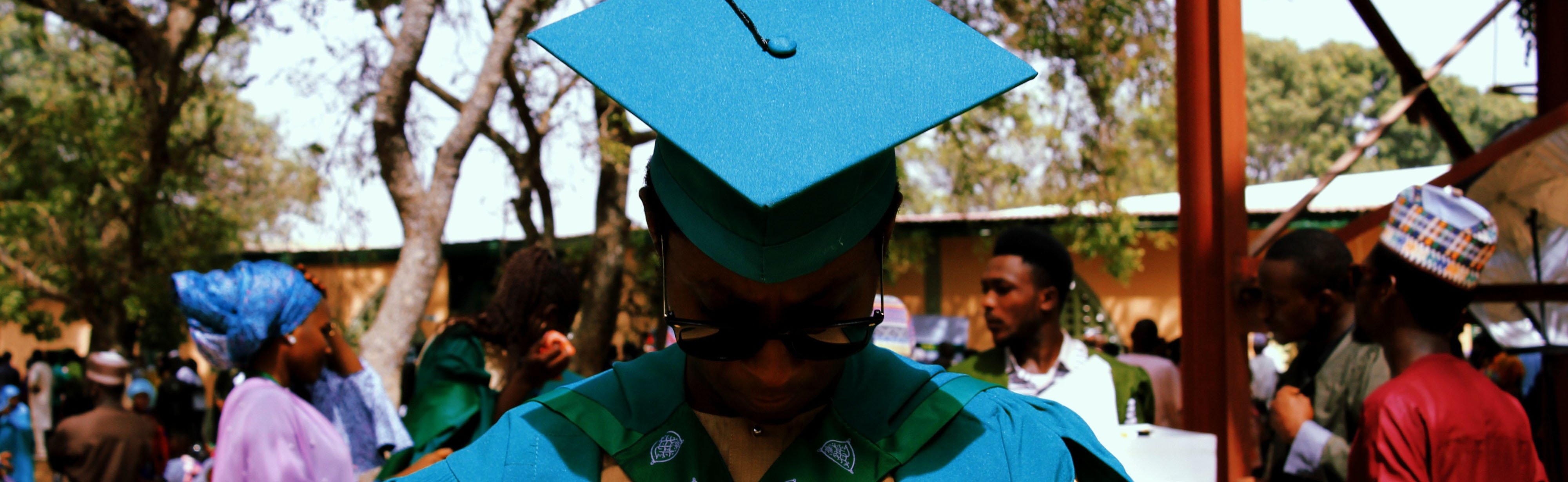 Graduate wearing graduation cap with head down