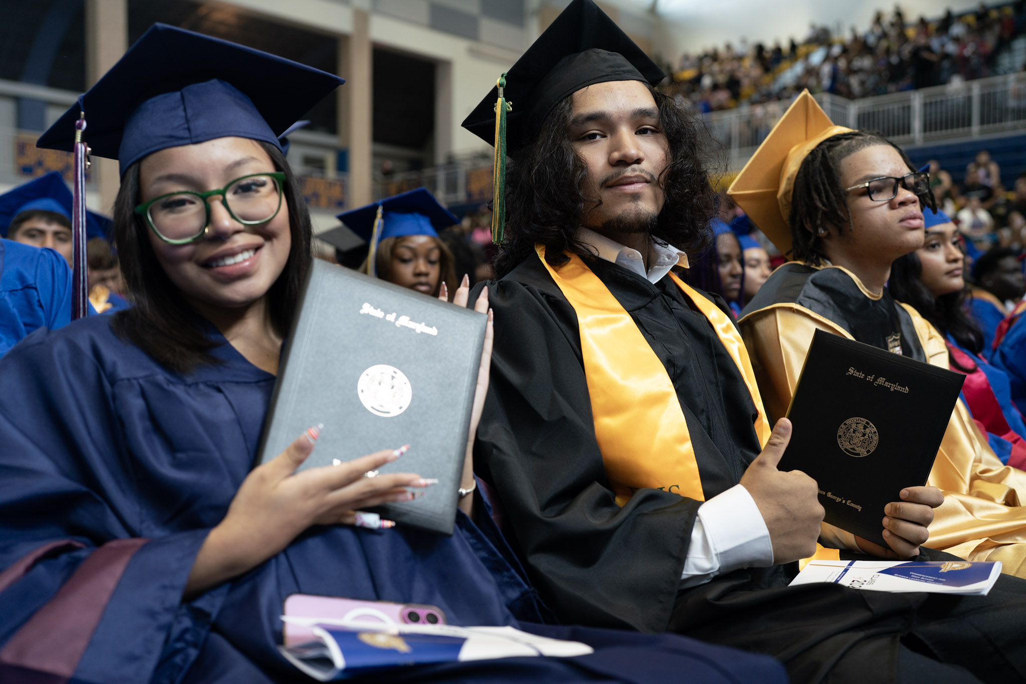 2025 boy girl graduate holding certificates