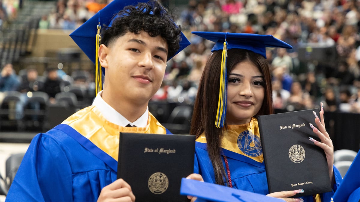 High-Point-High-School-graduates-holding-diplomas