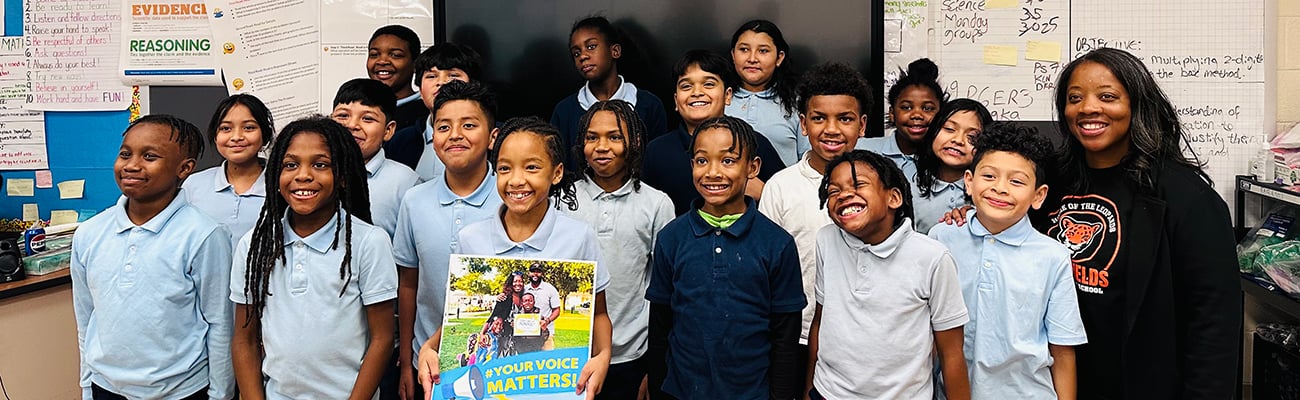 student group hold a Your Voice Matters poster