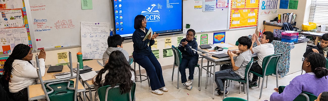 Teacher sitting with students