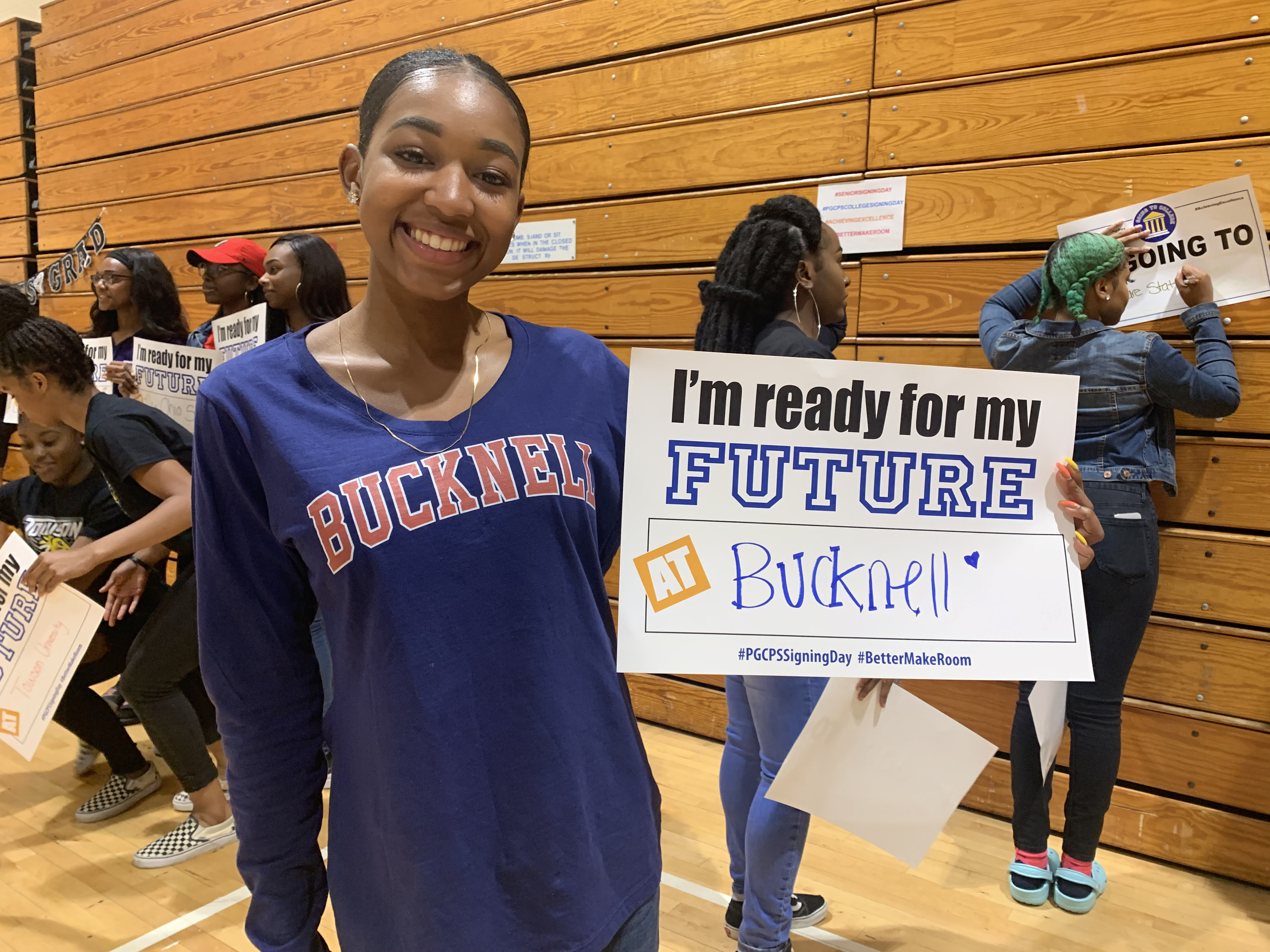 Student Holding Bucknell College Decision Sign.jpg