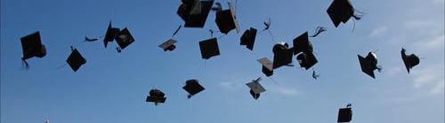 Graduation caps in the air