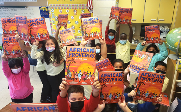 students-holding-up-African-Proverbs-books.png