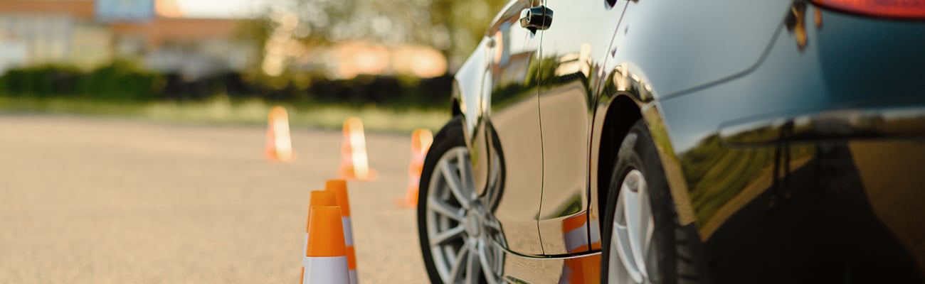 corner-of-car-in-parking-lot-orange-cones