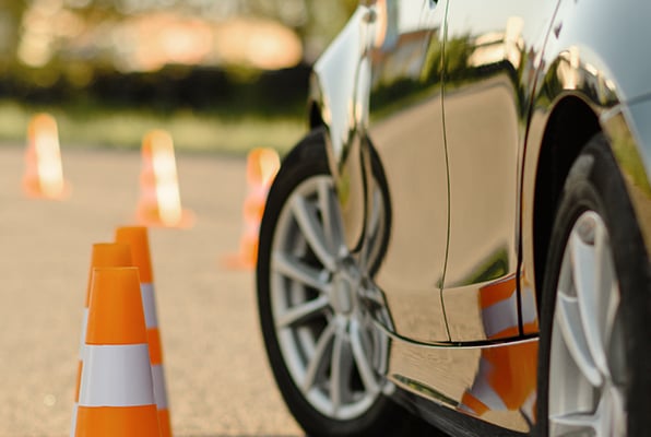 corner-of-car-in-parking-lot-orange-cones