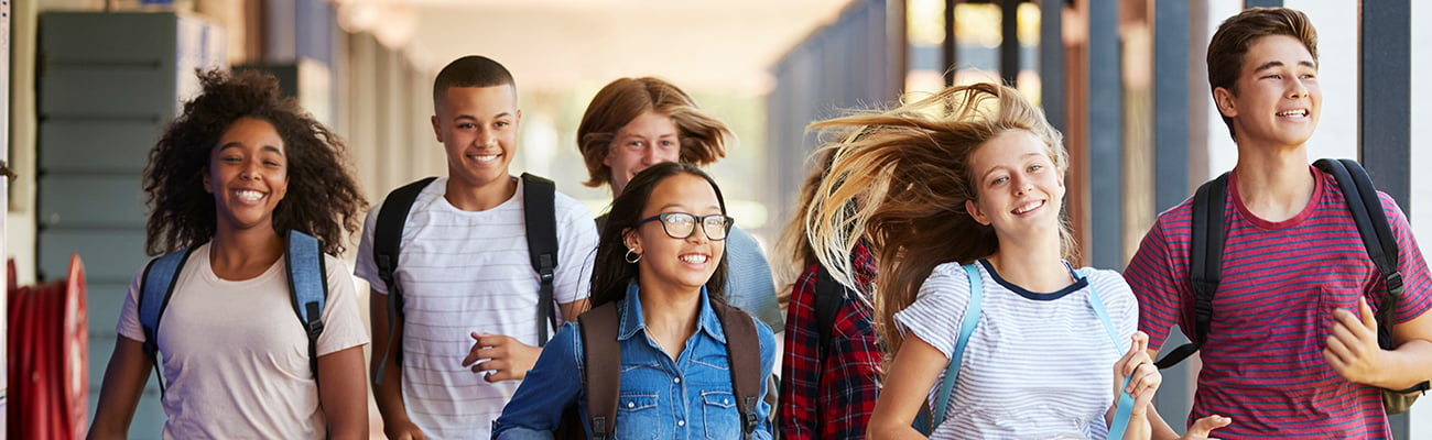 secondary-students-walking-with-backpacks-smiling