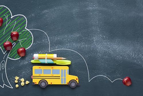back-to-school-yellow-school-bus-tree-with-apples-on-chalkboard-background
