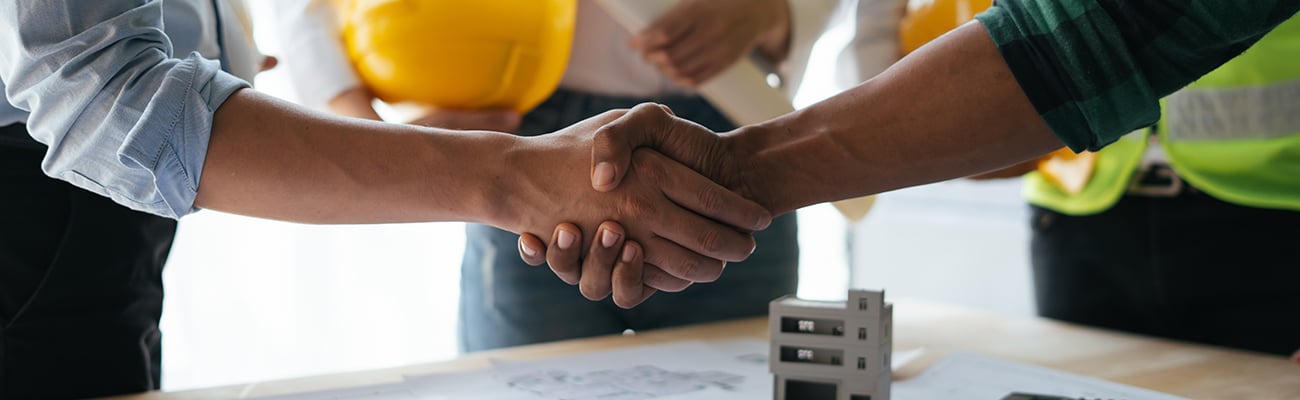 construction-blueprints-handshake-partnership