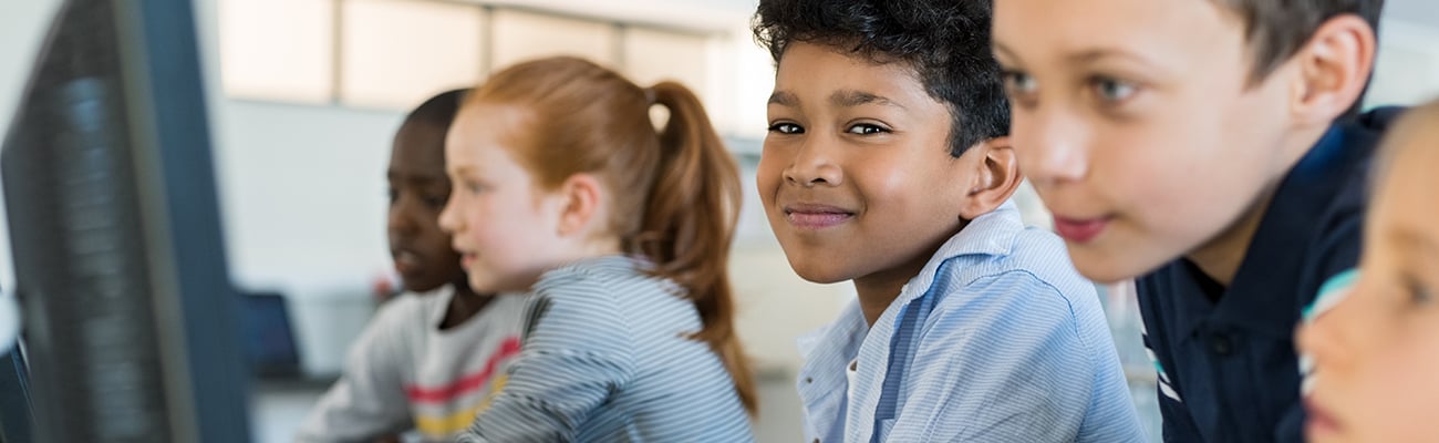 child and adult working at computer
