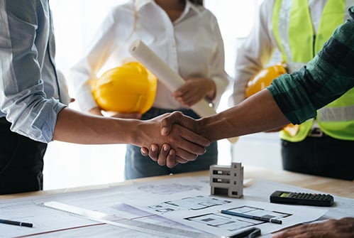 construction-blueprints-handshake-partnership